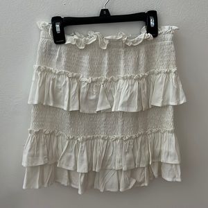 An adorable white Princess Polly mini skirt.